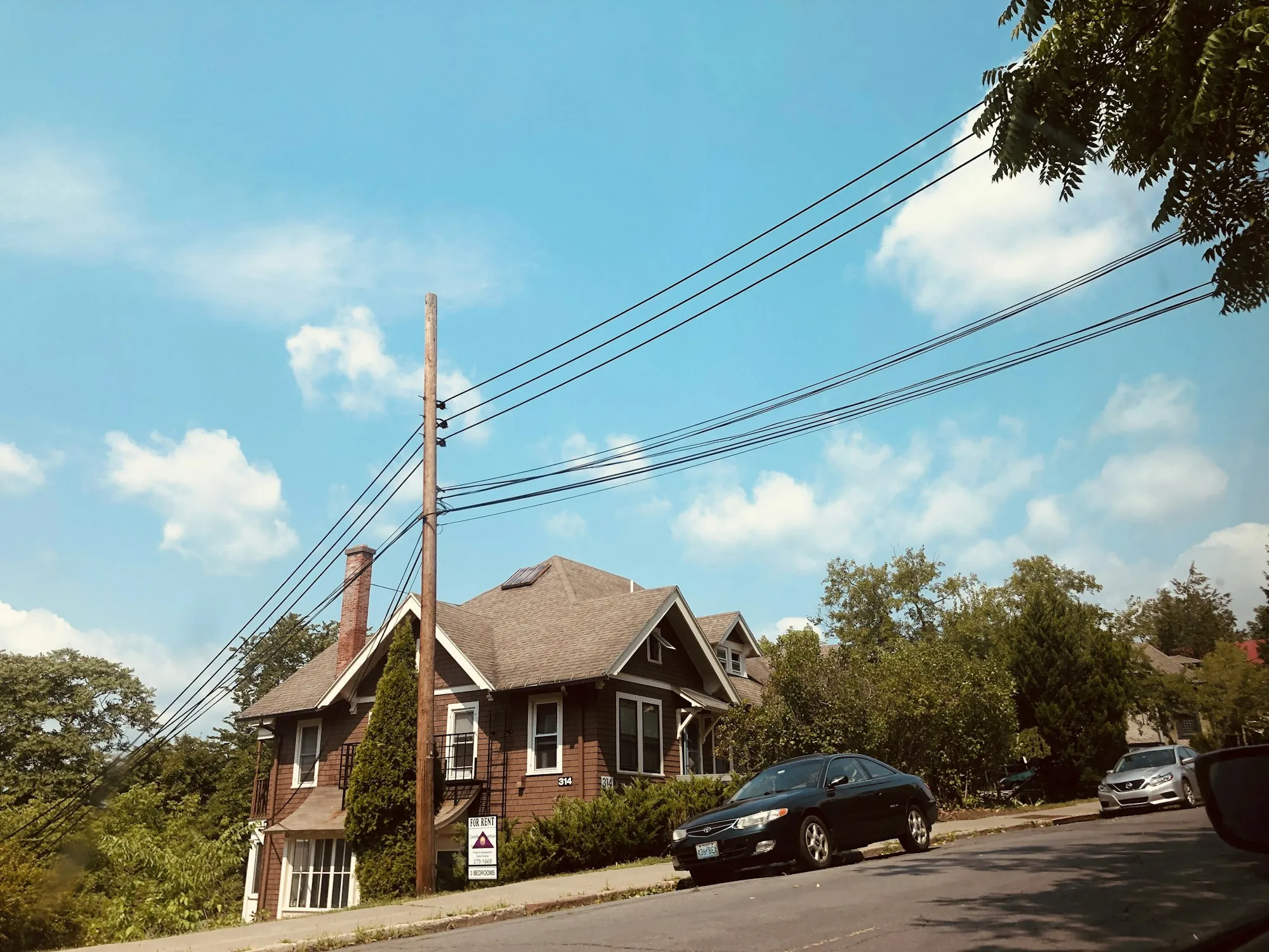 Two-story house on a quiet street lined with trees