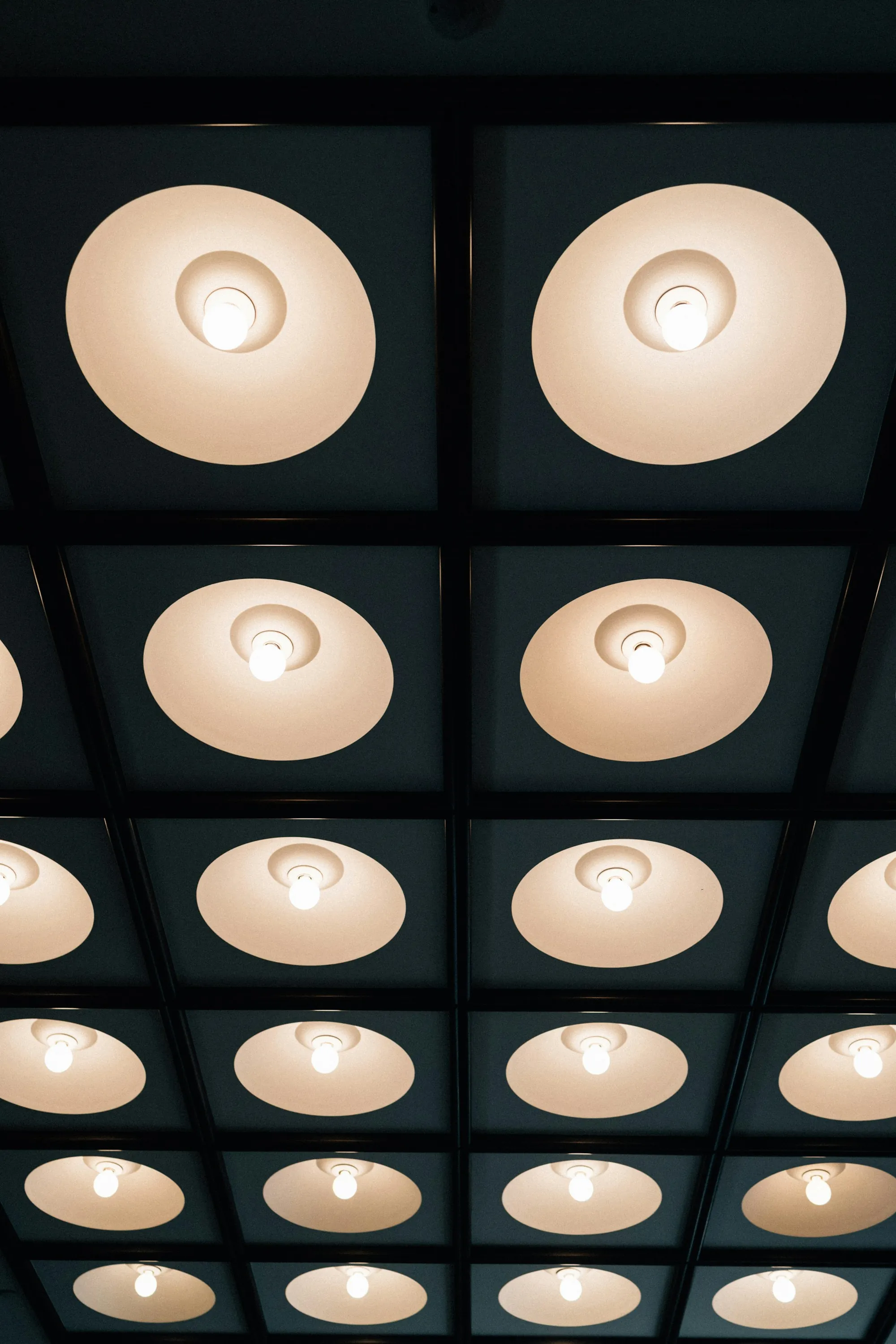 Warm recessed ceiling lights arranged in rows